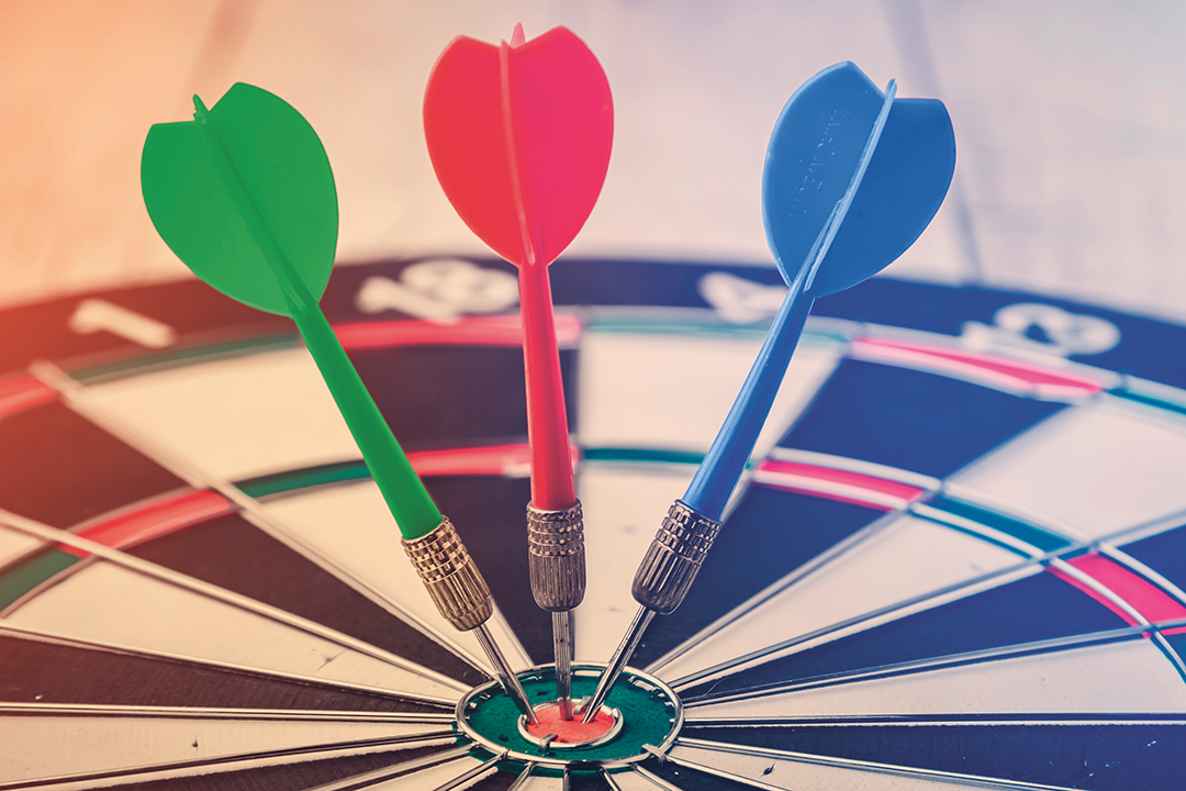 target dart with arrow over white wood background ,metaphor to target marketing or target arrow concept.